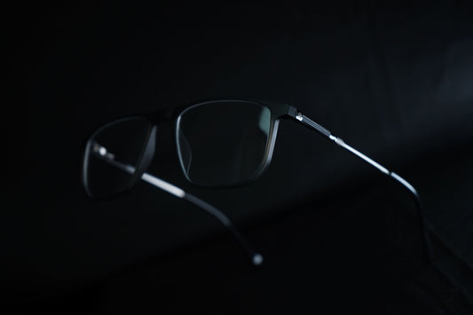 Dark eyeglasses on a black background